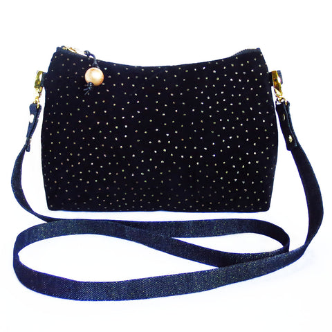 crossbody bag in black suede with gold metallic pin dots and dark metallic denim