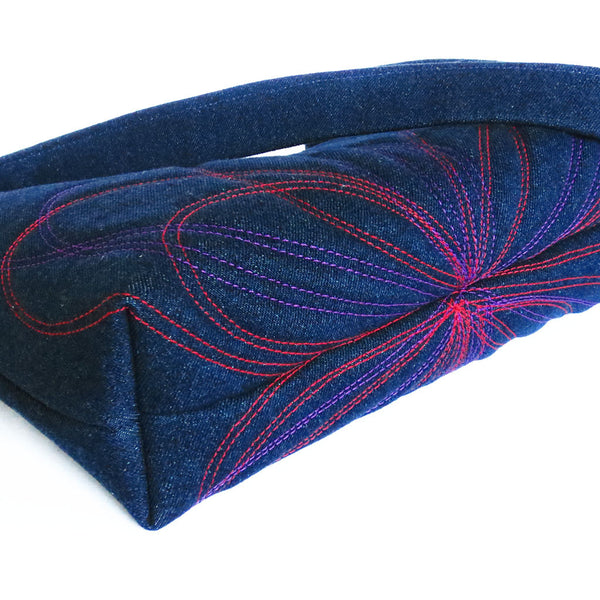 detail of the red and purple stitching on the persephone handbag from Holland Cox