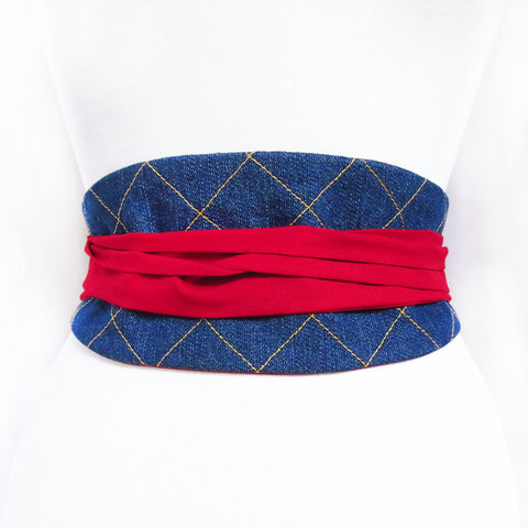 Denim obi style belt stitched with windowpane check in gold stitching, with long red ties wrapped and tied in the back.